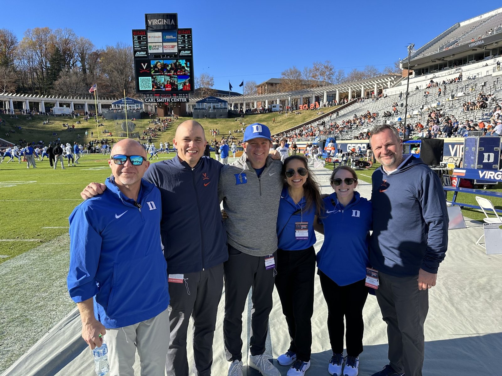 Dr. Gwathmey with colleagues on the football sideline at Virginia